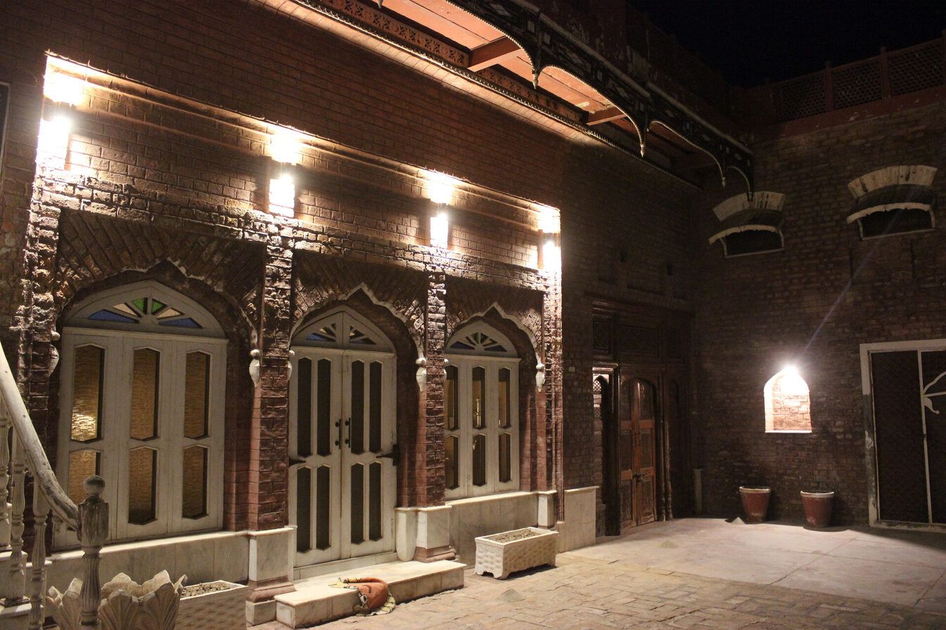 Haveli arcade glowing with lantern light at night
