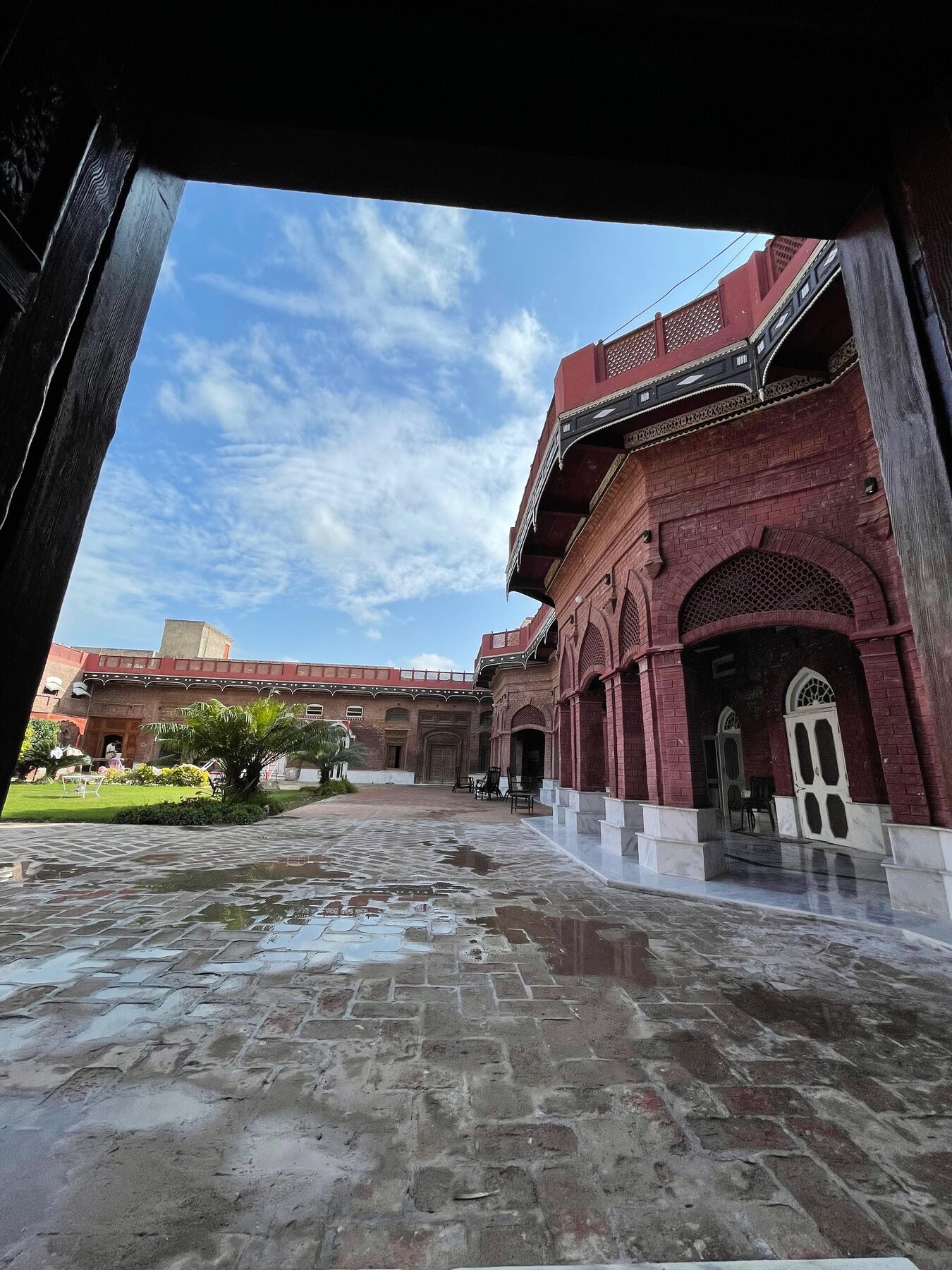 Archway framing the courtyard by day