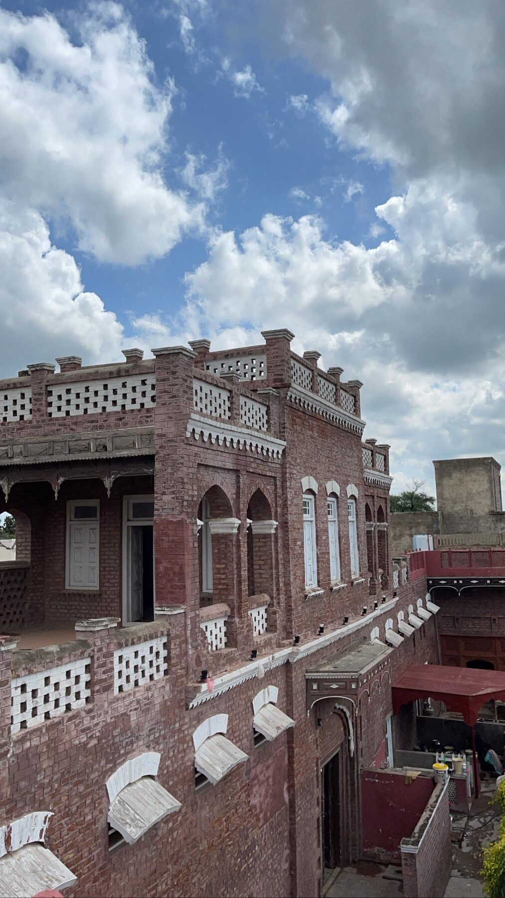 Upward view of the brick facade against the sky