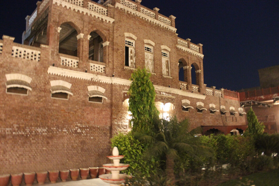 Grand carved entrance door lit at night