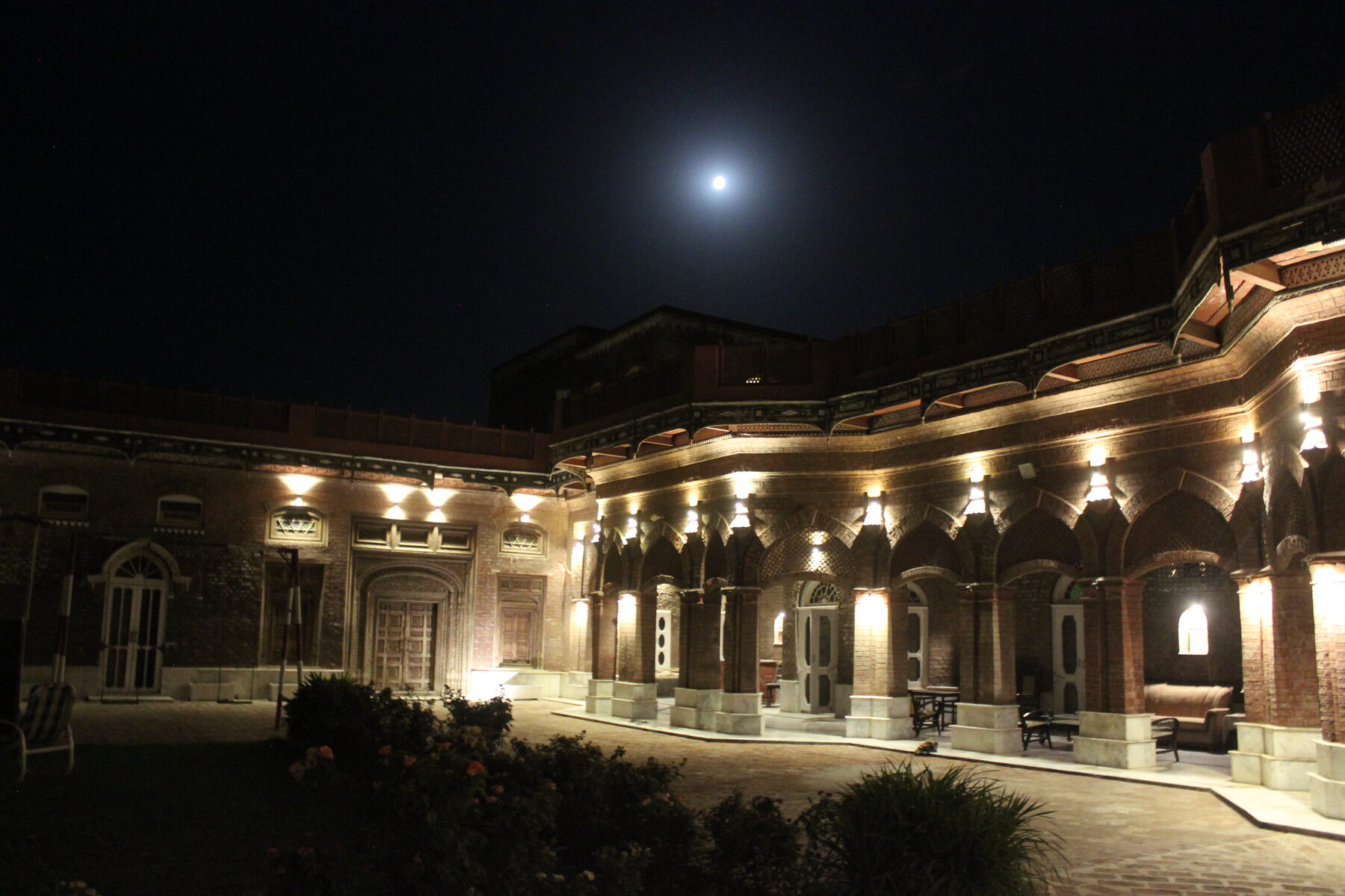 Muhammad Khan Haveli courtyard lit at night, moon overhead