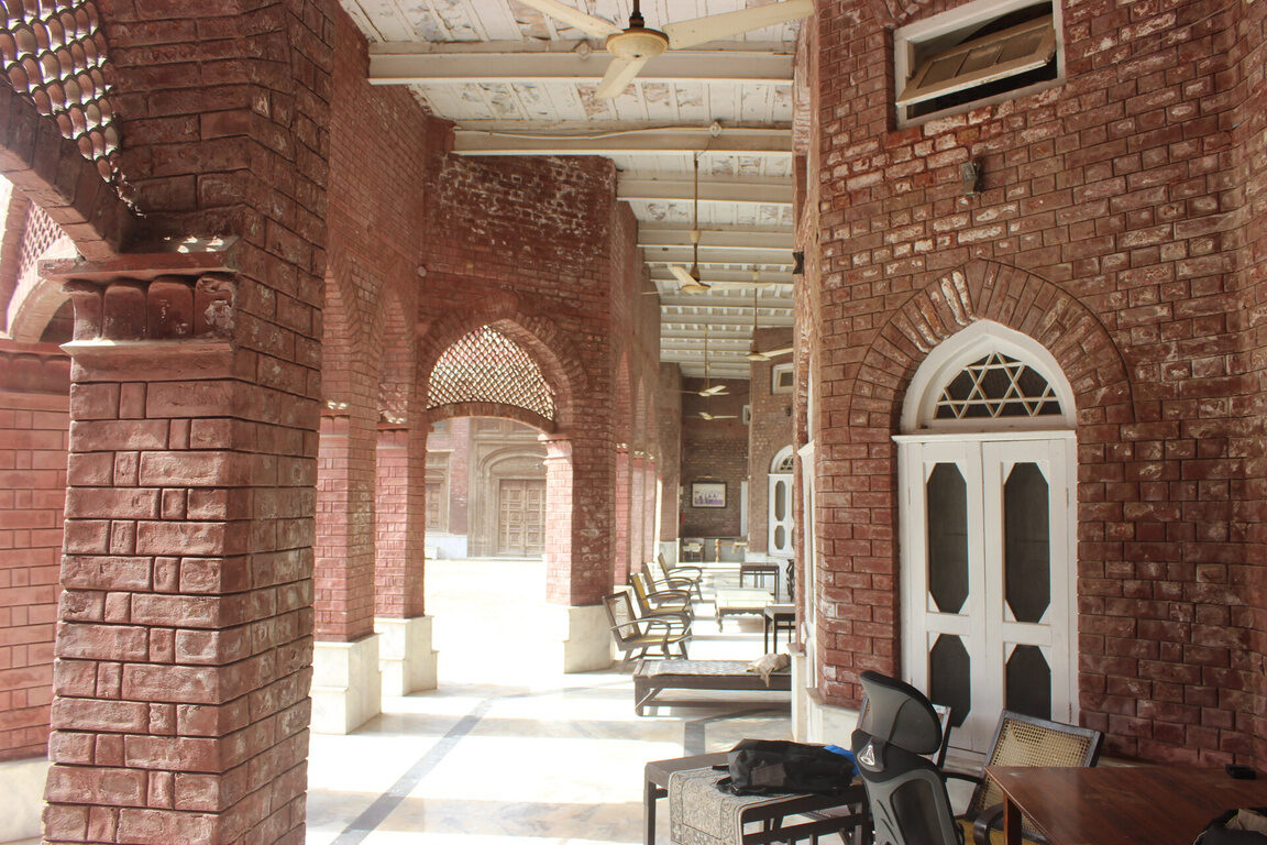 Arched interior corridor lit at night