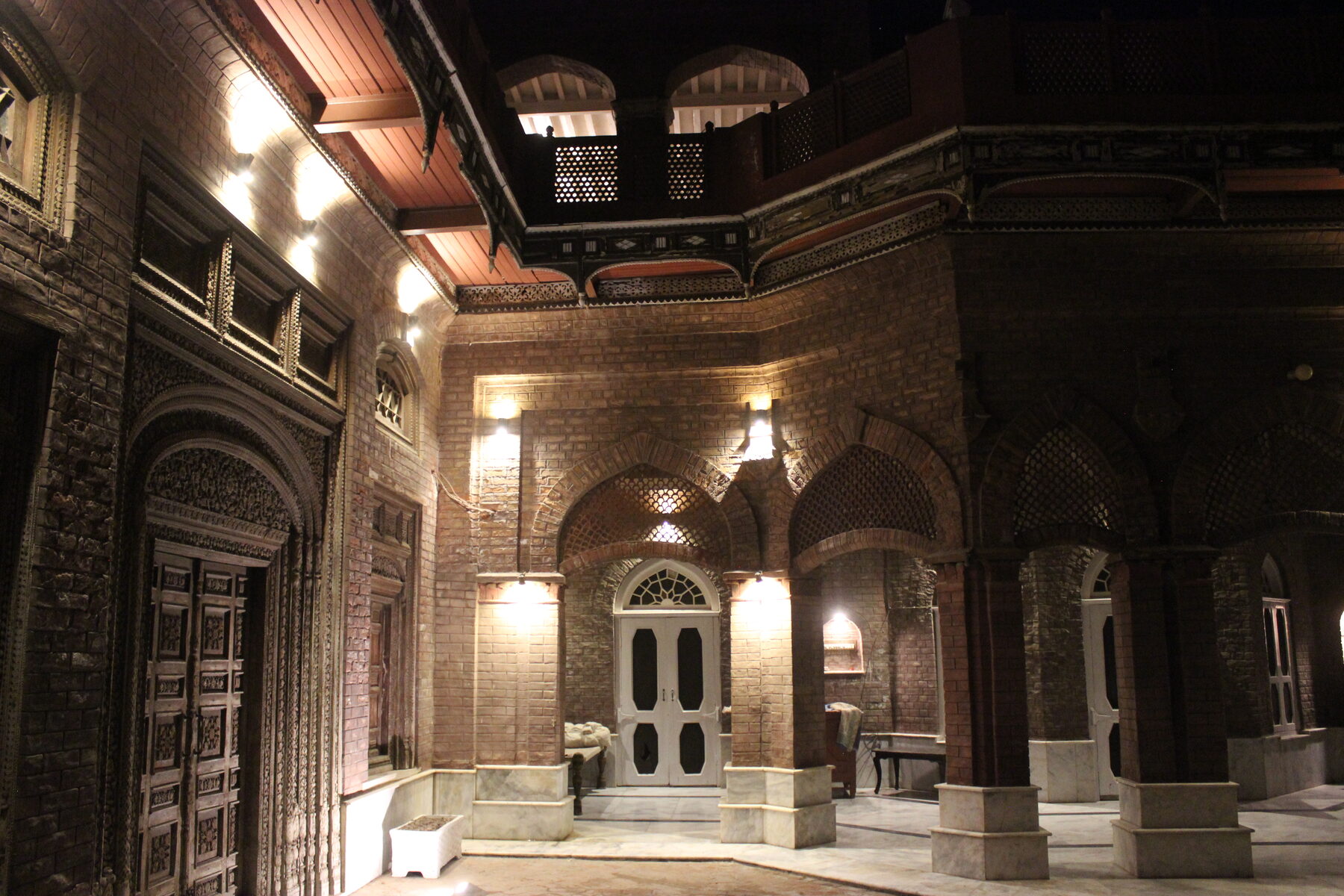 Arched courtyard corner lit at night