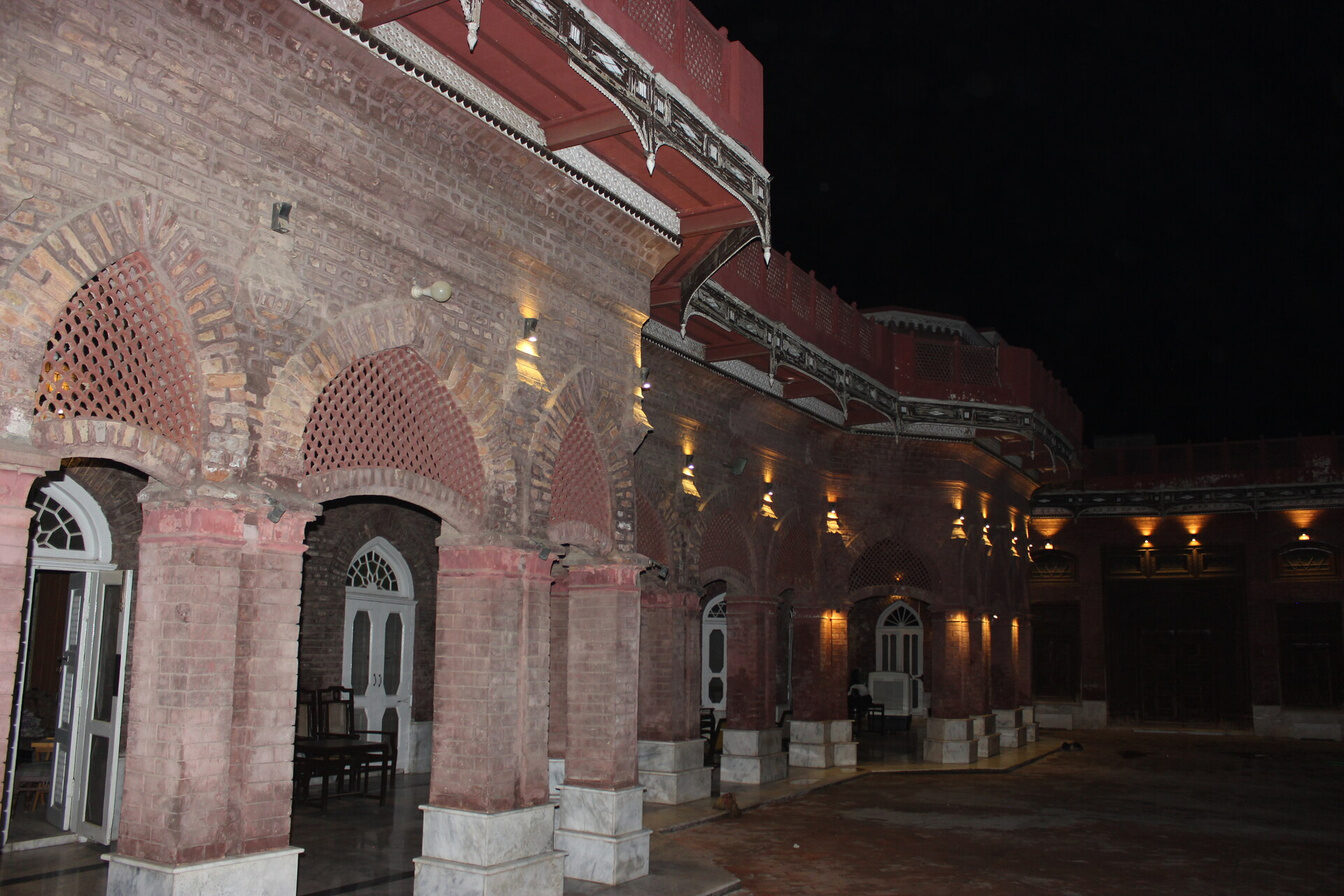 Main tower facade of the haveli lit at night