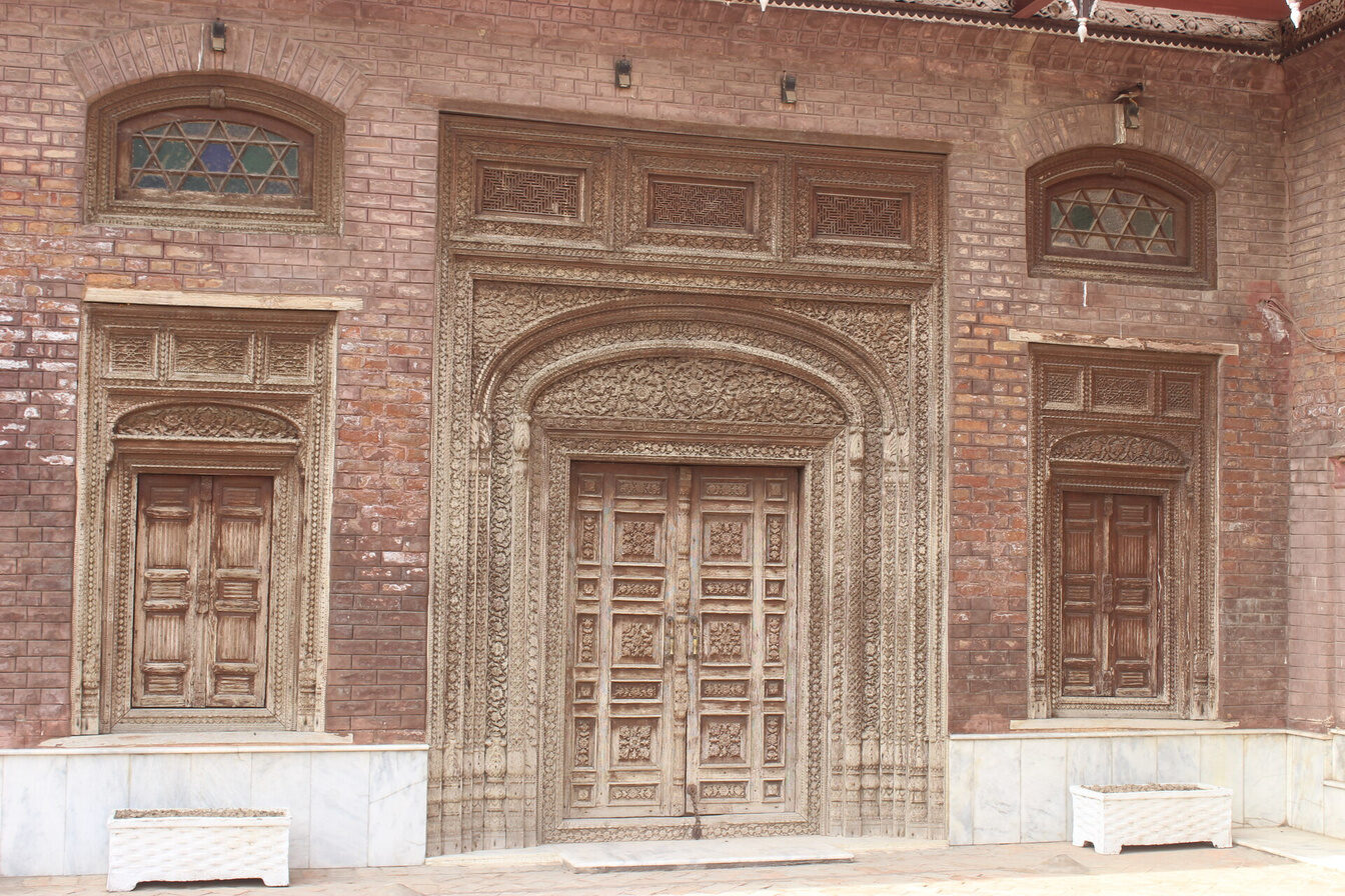 Carved doorways along the arcade